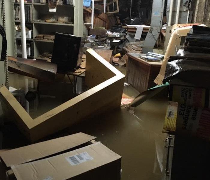 Rain has caused the business to flood and left boxes floating and all equipment shifted together in the 6" of water.